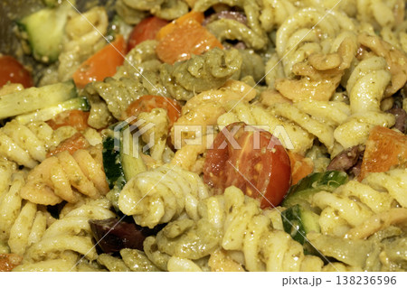 Close up of pasta pesto with salad vegetables Close up of pasta pesto with salad vegetables 138236596
