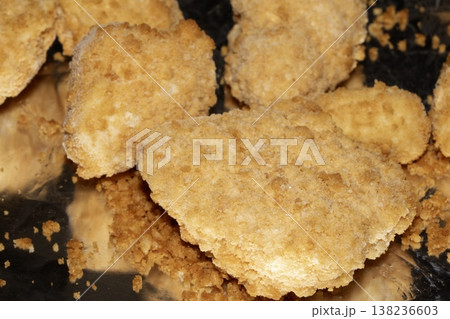 Close up of breaded fish scampi pieces on a tin foil base ready for cooking Close up of breaded fish scampi pieces on a tin foil base ready for cooking 138236603