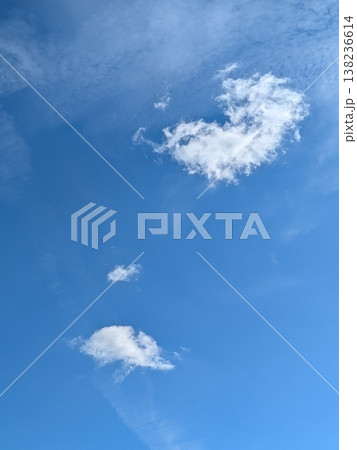 Beautiful blue summer air with fluffy white clouds and chem trail lines across the sky Beautiful blue summer air with fluffy white clouds and chem trail lines across the sky 138236614