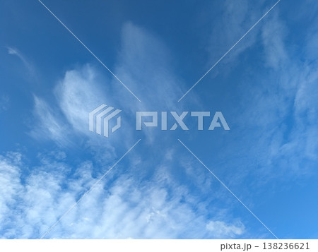 Beautiful blue summer air with fluffy white clouds and chem trail lines across the sky Beautiful blue summer air with fluffy white clouds and chem trail lines across the sky 138236621
