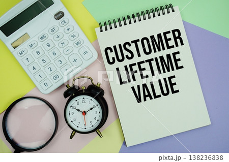 CLV Customer Lifetime Value text with calculator, alarm clock and magnifying glass 138236838
