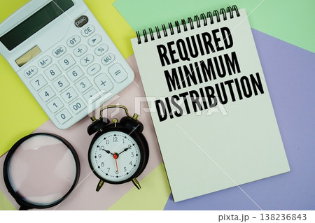 Required Minimum Distribution text with calculator, alarm clock and magnifying glass Required Minimum Distribution text with calculator, alarm clock and magnifying glass 138236843