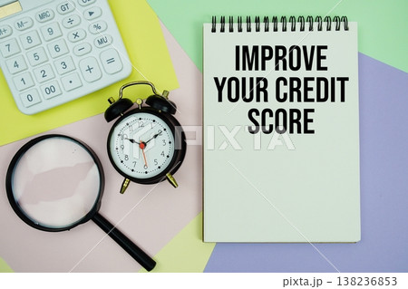 Improve Your Credit Score text with calculator, alarm clock and magnifying glass 138236853