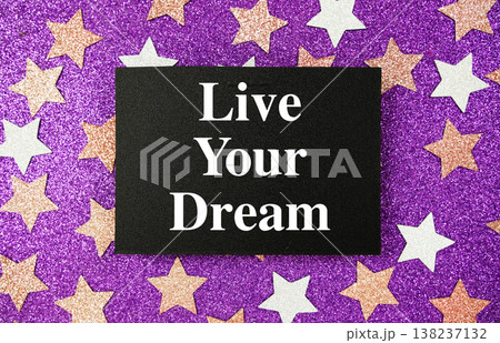 "Live Your Dream" quotes on paper card with purple glitter background with pink and white stars 138237132