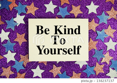 "Be Kind To Yourself" quotes on paper card with purple glitter background with white, pink and blue stars 138237137