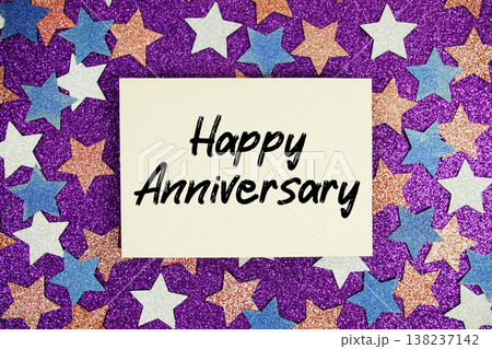 "Happy Anniversary" quotes on paper card with purple glitter background with white, pink and blue stars 138237142