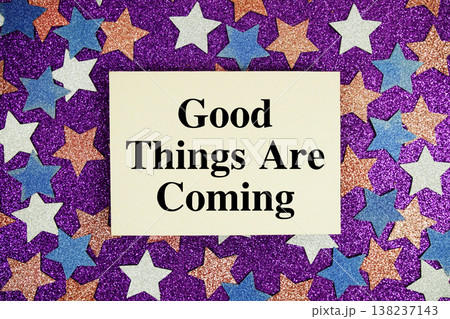 "Good Things Are Coming" quotes on paper card with purple glitter background with white, pink and blue stars 138237143