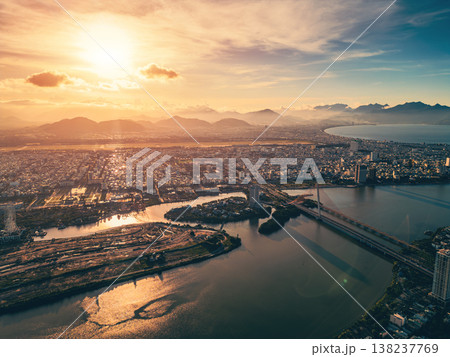 sunny sunset in coastal Da Nang city, Han river and Hai Chau district with bridges, skyscraper hotels and resorts by blue sea of Danang, Vietnam, aerial drone view sunny sunset in coastal Da Nang city, Han river and Hai Chau district with bridges, skyscraper hotels and resorts by blue sea of Danang, Vietnam, aerial drone view 138237769