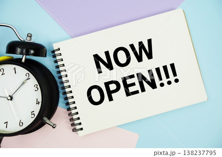 Now Open text written on notepad with alarm clock flat lay on multicolor pastel background Now Open text written on notepad with alarm clock flat lay on multicolor pastel background 138237795