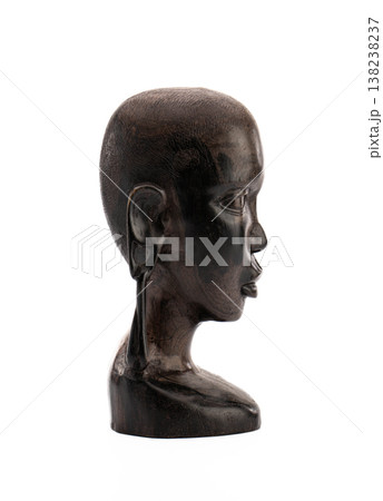 Sculpture of African-inspired head, side view, textured surface, neutral tone 138238237