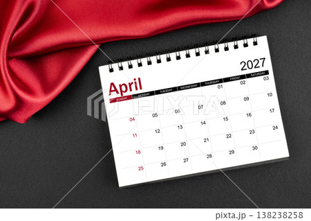April 2027 Monthly desk calendar with red silk on black leather background. 138238258