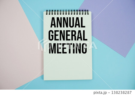 Annual General Meeting text written on notepad flat lay on multicolor pastel background 138238287