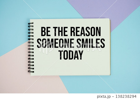 Be The Reason Someone Smiles Today text written on notepad flat lay on multicolor pastel background 138238294