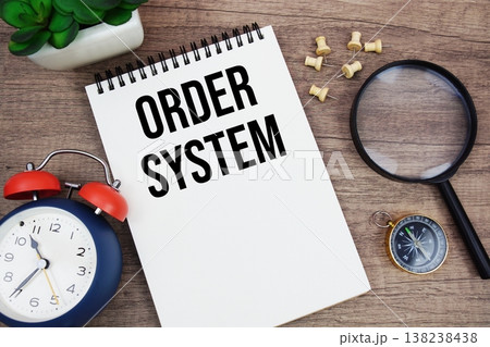 Order System text written on notepad with alarm clock, compass and magnifying glass flat lay on wooden background 138238438