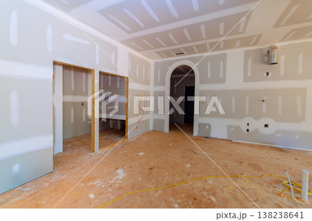 Workers prepare space for drywall installation, wall finishing in home renovation. 138238641