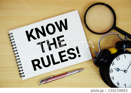 Know The Rules! text written on notepad with alarm clock and magnifying glass flat lay on wooden background 138238663