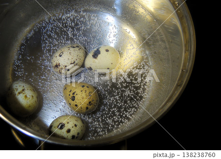 Quail Eggs In A Boiling Water Close Up. Quail Eggs Boiling in Water in Steel Pan   138238760