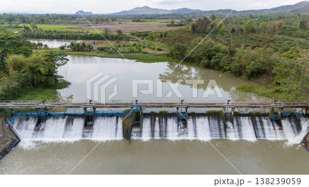 Aerial view of small spillway in Pa Daet district in Chiang Rai province of Thailand. Spillway, passage for surplus water over or around a dam when the reservoir itself is full. 138239059