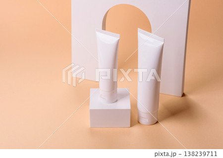 A white empty plastic or aluminum tube for cream, paste as a mockup. An empty cosmetic tube mockup A white empty plastic or aluminum tube for cream, paste as a mockup. An empty cosmetic tube mockup 138239711