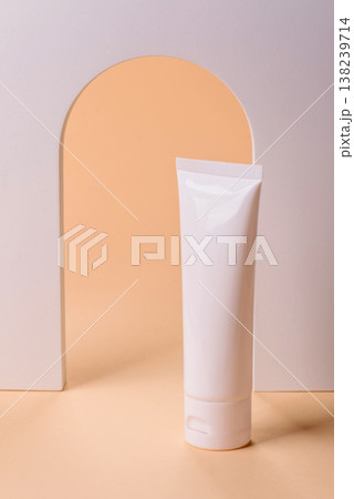 A white empty plastic or aluminum tube for cream, paste as a mockup. An empty cosmetic tube mockup 138239714