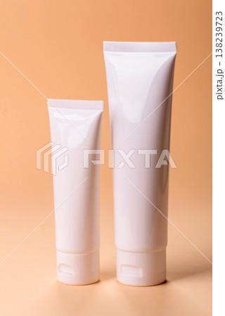 A white empty plastic or aluminum tube for cream, paste as a mockup. An empty cosmetic tube mockup 138239723