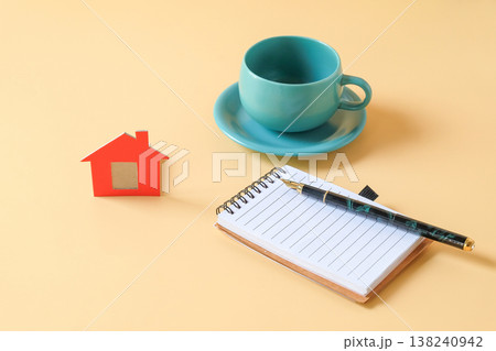 Small red dollhouse with booknote and pen. 138240942