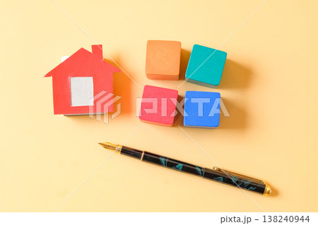 Small red dollhouse with wood cube. 138240944