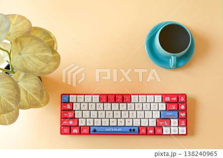 A cup of coffee with Red keyboard on desk. 138240965