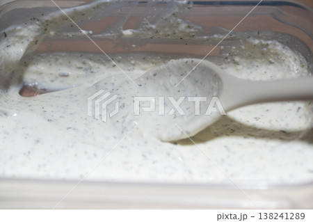Creamy Herb Sauce Being Stirred with a Spoon Creamy Herb Sauce Being Stirred with a Spoon 138241289