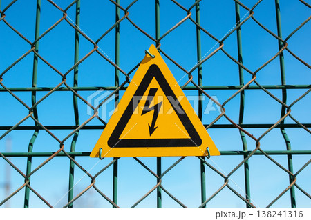 High Voltage Warning Sign on Chain-Link Fence 138241316