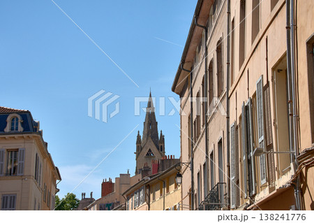 Gothic church tower rising among historic buildings in Aix-en-Provence under a clear blue sky in France Gothic church tower rising among historic buildings in Aix-en-Provence under a clear blue sky in France 138241776