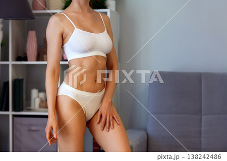young adult woman in white underwear at home young adult woman in white underwear at home 138242486