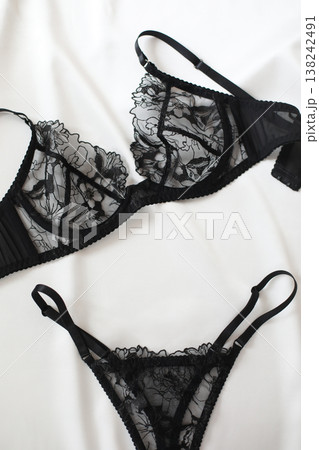 Black lacy sexy lingerie over white. Shopping and fashion concept. glamorous stylish sexy lace lingerie, woman accessories on white background. Top view point, flat lay. 138242491