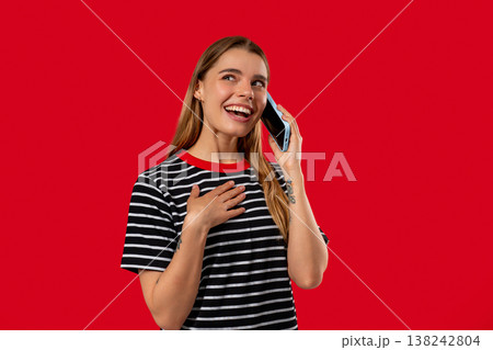 Beautiful blonde woman talking by phone, nice joke, smiling. Young lady on red Beautiful blonde woman talking by phone, nice joke, smiling. Young lady on red 138242804