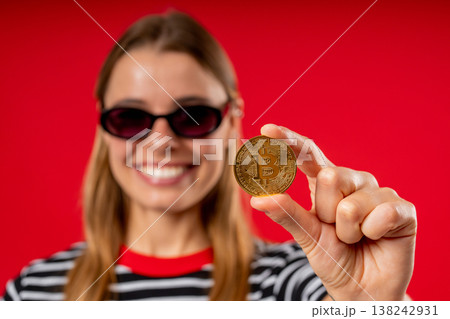 Mature Woman With Bitcoin, Crypto Currency. Golden Coin On Red Background. Mature Woman With Bitcoin, Crypto Currency. Golden Coin On Red Background. 138242931