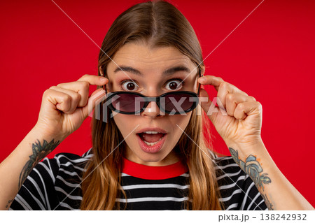 Amazed Pretty Woman Expresses Wow. Impressed Teen Girl On Red. Great News Amazed Pretty Woman Expresses Wow. Impressed Teen Girl On Red. Great News 138242932