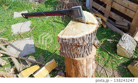 Axe in a log. Spring background. Axe in a log. Spring background. 138243247