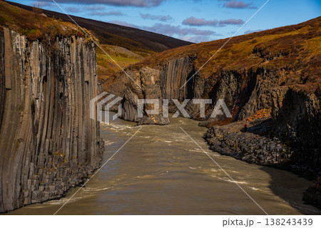 Discover the unique landscapes of Studlagil Canyon in Iceland, featuring striking basalt columns and a clear turquoise river flowing through dramatic rock formations. Discover the unique landscapes of Studlagil Canyon in Iceland, featuring striking basalt columns and a clear turquoise river flowing through dramatic rock formations. 138243439