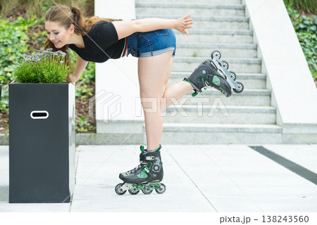 Young woman riding roller skates 138243560