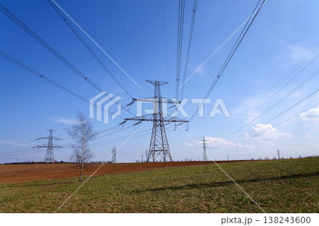 Electricity pylons conducting current from distribution power station, blackout and grid stability concept, copy space 138243600