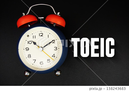 TOEIC text with alarm clock on black background 138243683