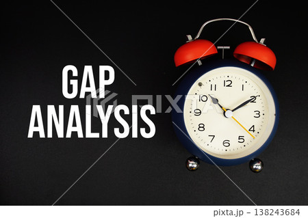 Gap Analysis text with alarm clock on black background 138243684