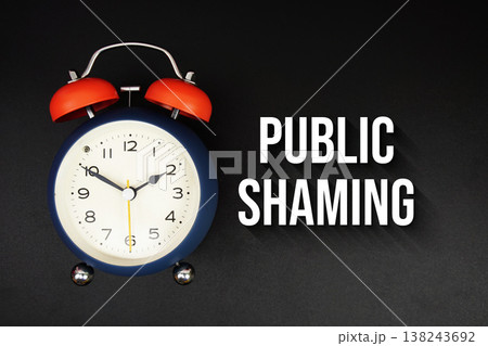 Public Shaming text with alarm clock on black background Public Shaming text with alarm clock on black background 138243692