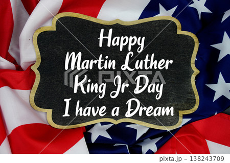 Happy Martin Luther King Jr Day and I have a Dream message written on blackboard with American flag Happy Martin Luther King Jr Day and I have a Dream message written on blackboard with American flag 138243709