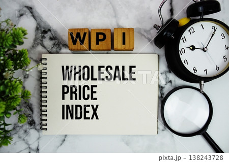WPI Wholesale Price Index text with alarm clock and magnifying glass on marble background 138243728