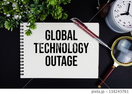Global Technology Outage text with alarm clock and magnifying glass 138243761