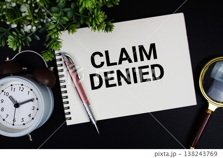 Claim Denied text with alarm clock and magnifying glass Claim Denied text with alarm clock and magnifying glass 138243769