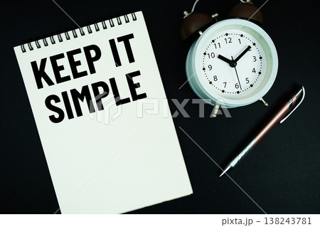 Keep It Simple text written on notepad with pen and alarm clock 138243781