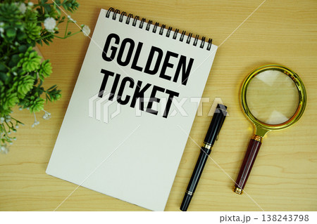 Golden Ticket text written on notepad with magnifying glass flat lay on wooden background Golden Ticket text written on notepad with magnifying glass flat lay on wooden background 138243798