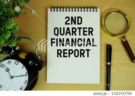2nd Quarter Financial Report written on notepad with alarm clock and magnifying glass on wooden background 2nd Quarter Financial Report written on notepad with alarm clock and magnifying glass on wooden background 138243799